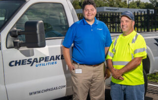 Chesapeake Utilities workers in front of truck