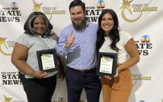 Three Chesapeake Utilities employees accept Stars of Delaware awards.