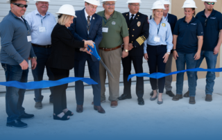 People in hard hats cutting the ribbon at the Safety Town ribbon-cutting ceremony